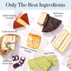 Selection of gourmet cheeses including Apple Smoked Cheddar, Truffle Moliterno, & Sage Derby, labeled on a white background