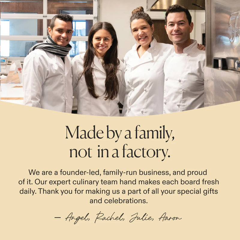 Charcuterie board team posing in a kitchen with message about family-made, handcrafted products.