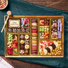 Assorted chocolates in a wooden box on a wood background