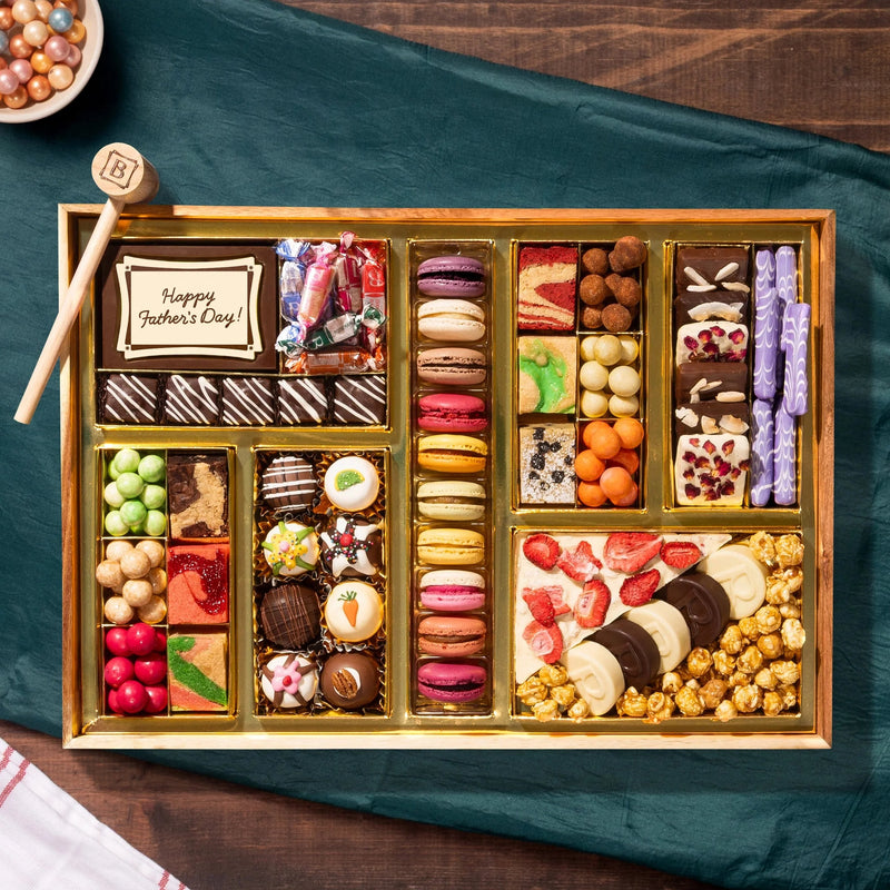 Assorted chocolates in a wooden box on a wood background
