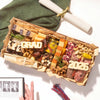 A graduation party charcuterie board with 'GRAD' and '2026' cheese letters, meats, cheeses, and nuts, styled with a diploma scroll and graduation photos.