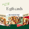 Charcuterie board with meats, cheeses, nuts, and fruits, promoting gift cards for cheese lovers.