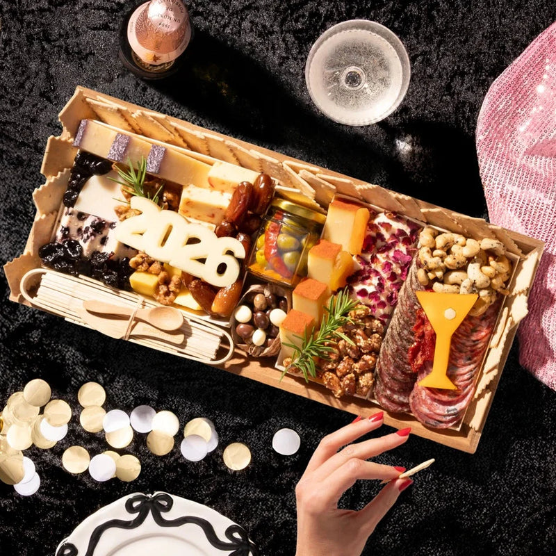 cheese and charcuterie board for new years with meats and cheeses and 2026 cheese cut out