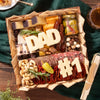 Charcuterie board for Father’s Day featuring meats, cheeses, nuts, pickles, and cheese cutouts spelling “DAD” and “#1”.