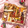 Large Mother's Day charcuterie board with meats, cheeses, dried fruits, nuts, and "MOM" and "XO" cheese cutouts.