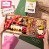 Mother's Day charcuterie box with gourmet snacks, "MOM" cheese cutout, and festive packaging for a thoughtful gift.