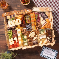 Father’s Day charcuterie board with assorted cheeses, meats, nuts, fruits, and themed decorations like “DAD” and “#1” cutouts.