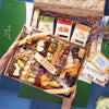 Easter themed charcuterie board filled with gourmet cheeses, meats, nuts, fruit, fig jam, and festive egg and bunny cheese cutouts.