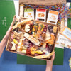 An Easter cheese board being unboxed, featuring bunny-shaped cheeses, crackers, cured meats, nuts, and honey arranged in a gift box with Boarderie packaging.