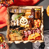 Halloween-themed cheese board with festive cheese shapes, figs, candy corn, nuts, and a small jar of fig jam, arranged without any meats