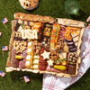 Patriotic charcuterie board with meats, cheeses, nuts, and cheese cutouts spelling “USA” and shaped like stars.