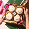 Mother’s Day cheese board featuring four brie wheels with carved messages saying I love you mom and fig marmalade.