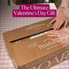 Valentine cheese board gift box being opened, labeled perishable and made fresh daily, perfect for a romantic celebration.