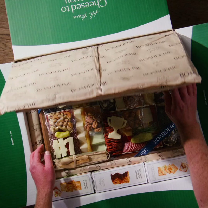 Dad charcuterie board gift box with meats, cheeses, nuts, and cheese cutouts shaped like “#1” and a trophy.