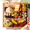 Premade charcuterie board with assorted cheeses, cured meats, olives, nuts, dried fruit, and rosemary on an acacia tray.