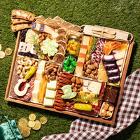 St. Patrick’s charcuterie board with gourmet cheeses, cured meats, figs, nuts, and festive cheese cutouts shaped like a shamrock, horseshoe, and leprechaun hat.
