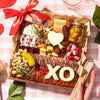 Romantic Valentine's Day charcuterie board for two featuring cured meats, cheeses, crackers, nuts, olives, and heart-shaped cheese with red ribbon bow.