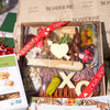 Charcuterie for Valentine’s Day featuring artisan meats, cheeses, nuts, pickled vegetables, and heart and XO-shaped cheese cutouts with love-themed ribbon.